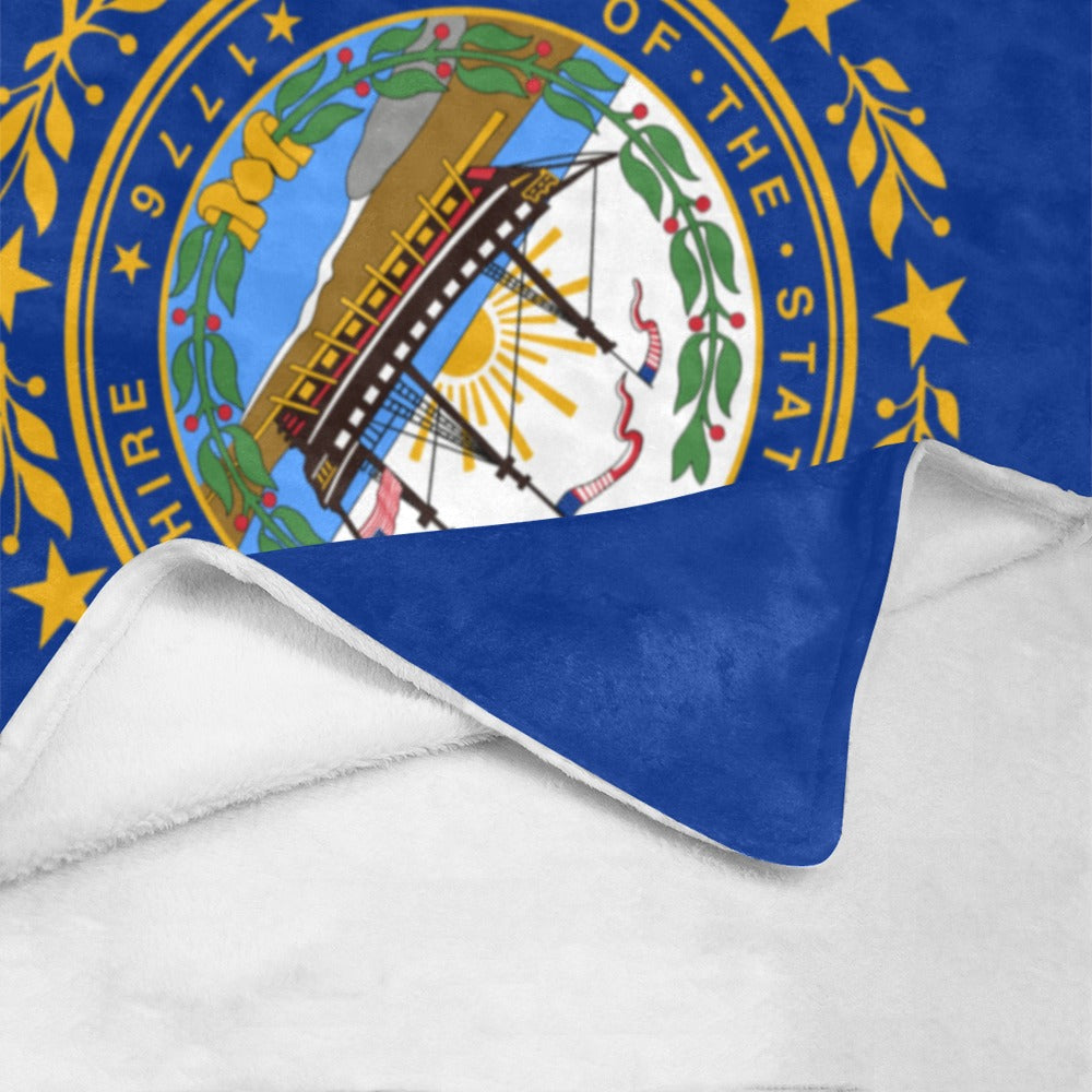 Blue and white blanket featuring New Hampshire's state emblem, Luv My Flag.