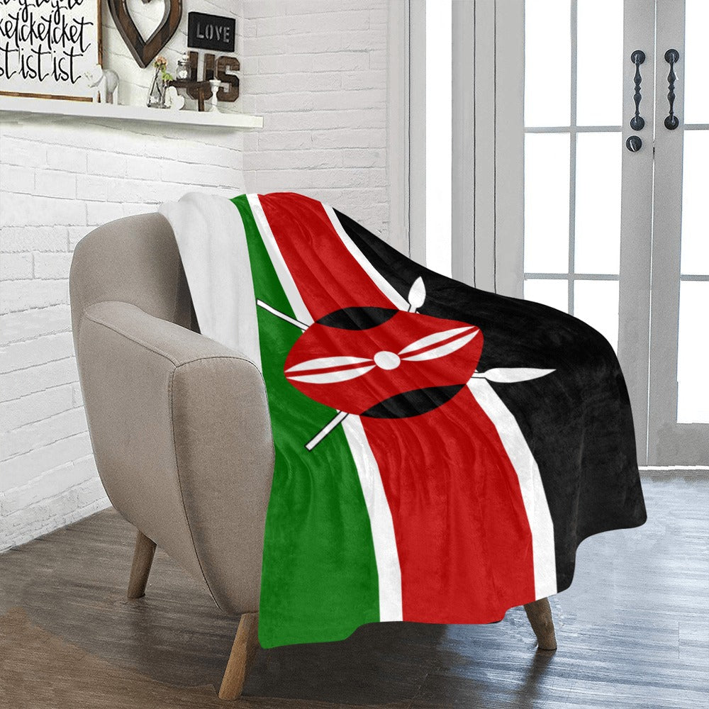 Cozy chair with Luv My Flag Kenya-themed blanket draped.