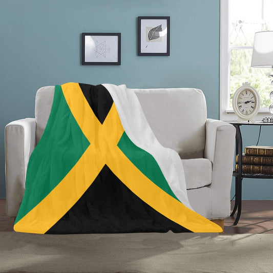 "Luv My Flag Jamaican-themed blanket on a cozy sofa."