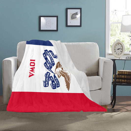 Luv My Flag Iowa blanket draped on beige couch.