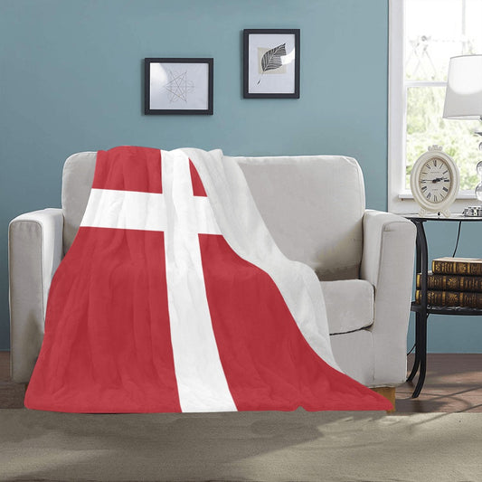 Cozy sofa with Luv My Flag Danish-themed throw blanket.