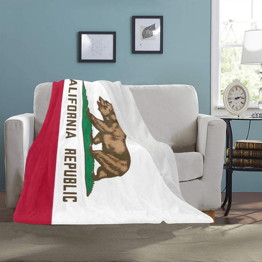 Cozy throw with California flag draped over beige couch. Luv My Flag.