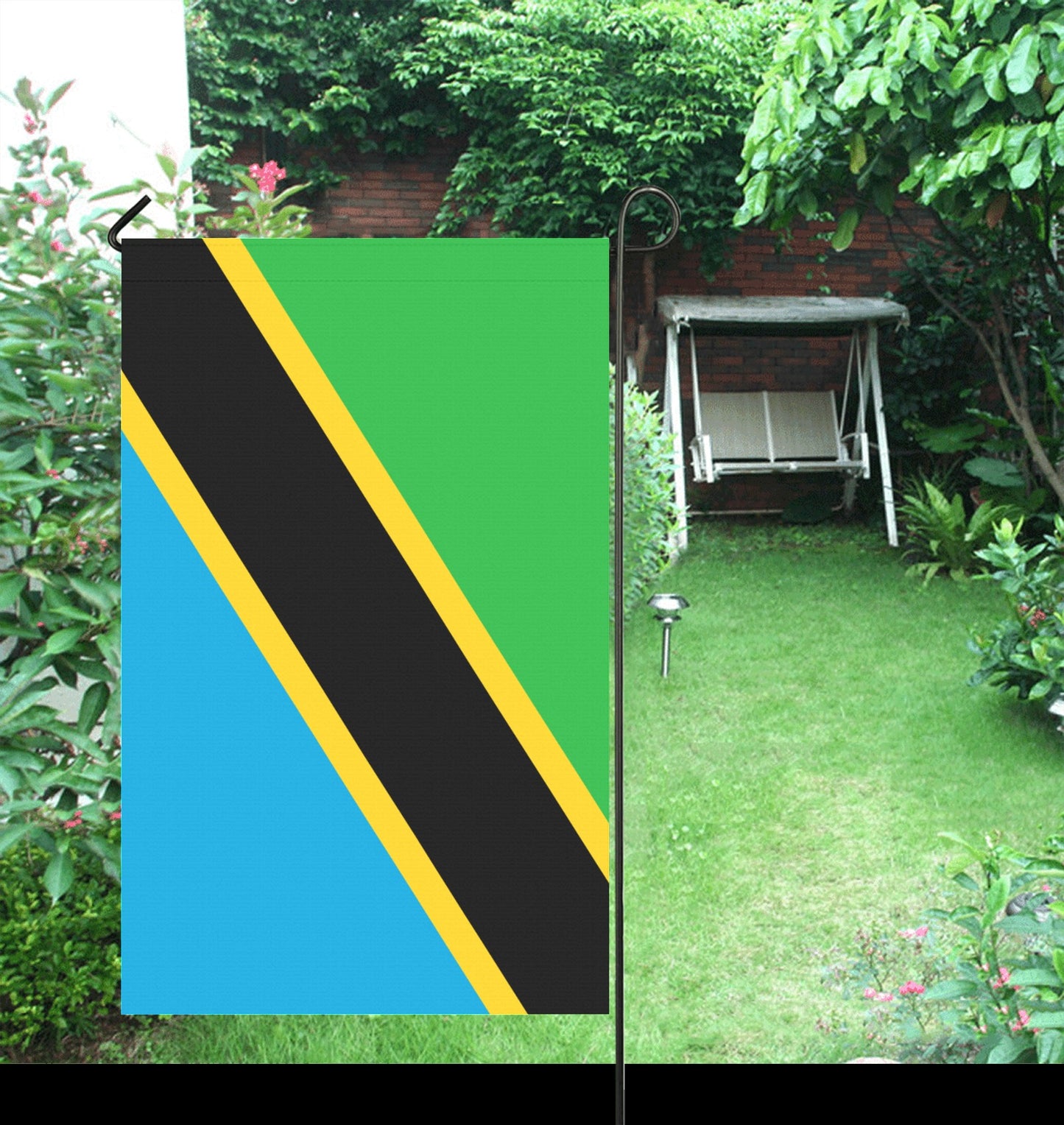 Luv My Flag Tanzania flag in a lush garden.