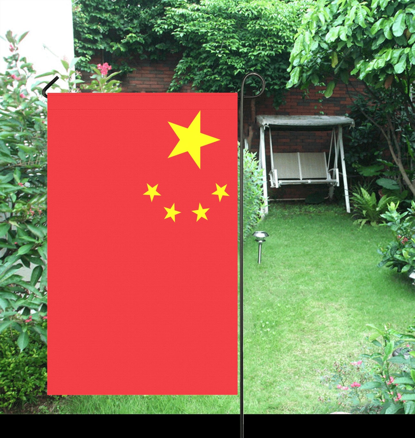 Luv My Flag China flag displayed in a lush garden.