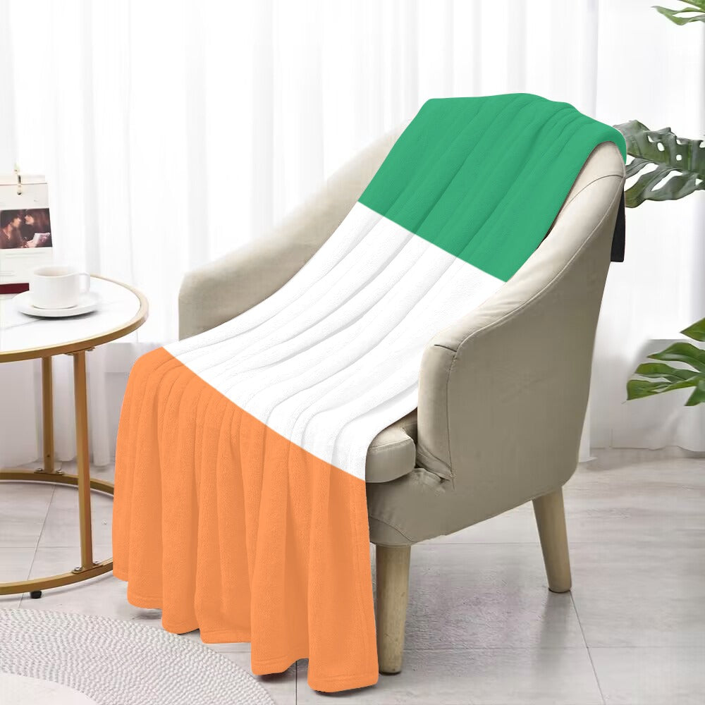 Green, white, orange striped blanket on chair. Luv My Flag.
