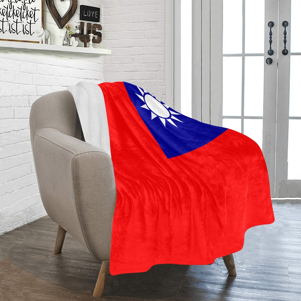 Cozy chair with Luv My Flag Taiwan-themed blanket draped.