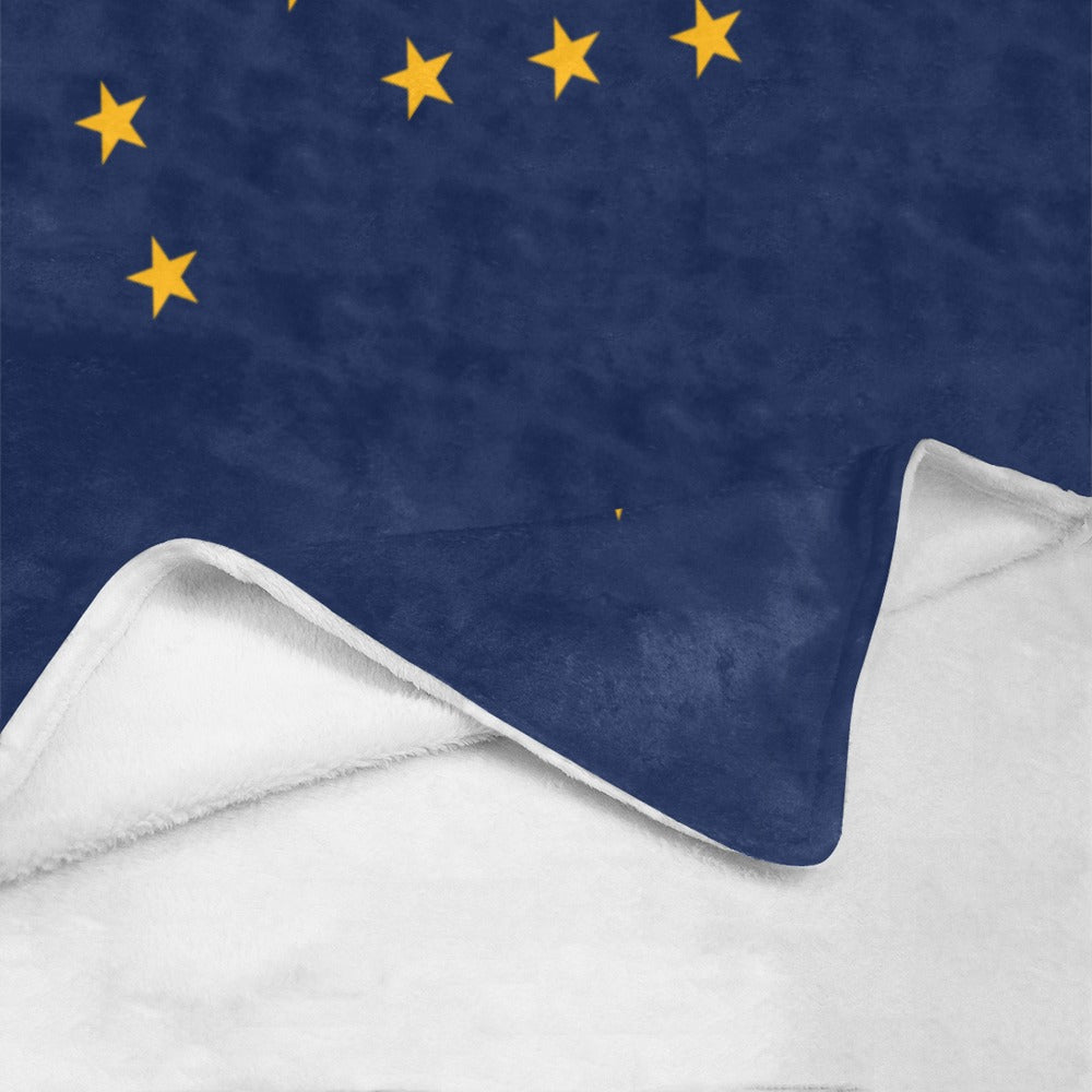 Blue and white blanket with yellow stars; Luv My Flag.