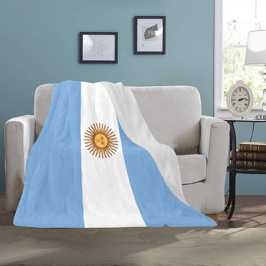 Luv My Flag Argentina blanket draped over beige sofa.