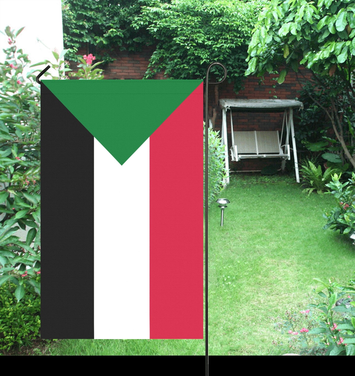 Luv My Flag Sudan garden flag amidst lush greenery.