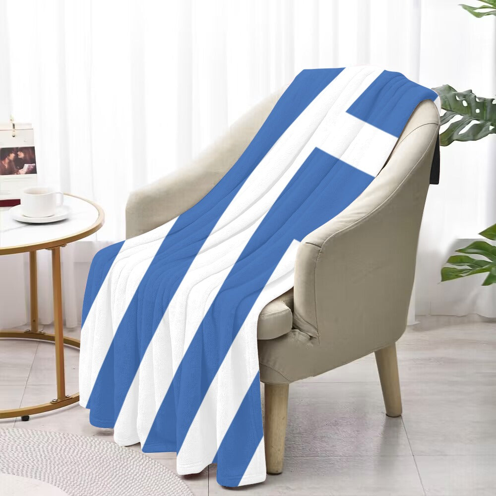 Cozy chair with Luv My Flag blue-striped blanket.