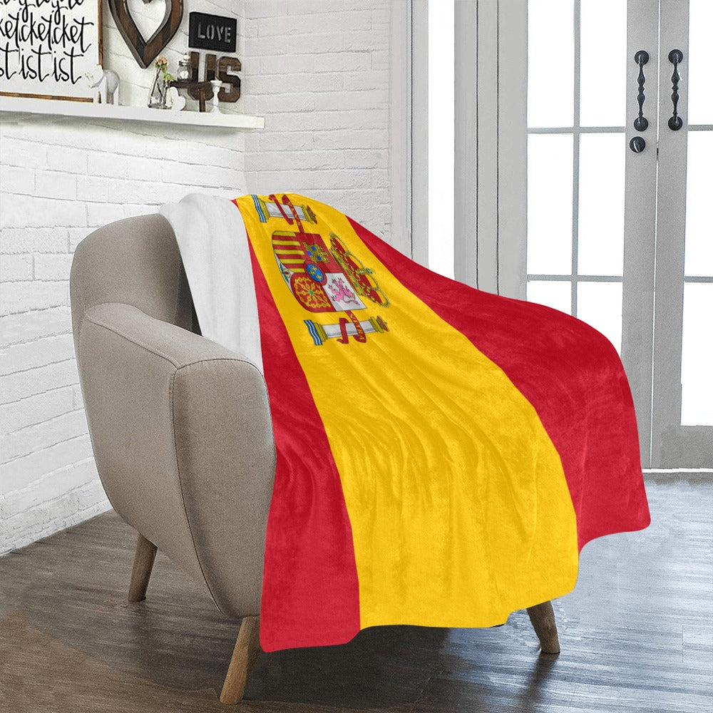 Cozy chair with Luv My Flag Spain-themed blanket draped.