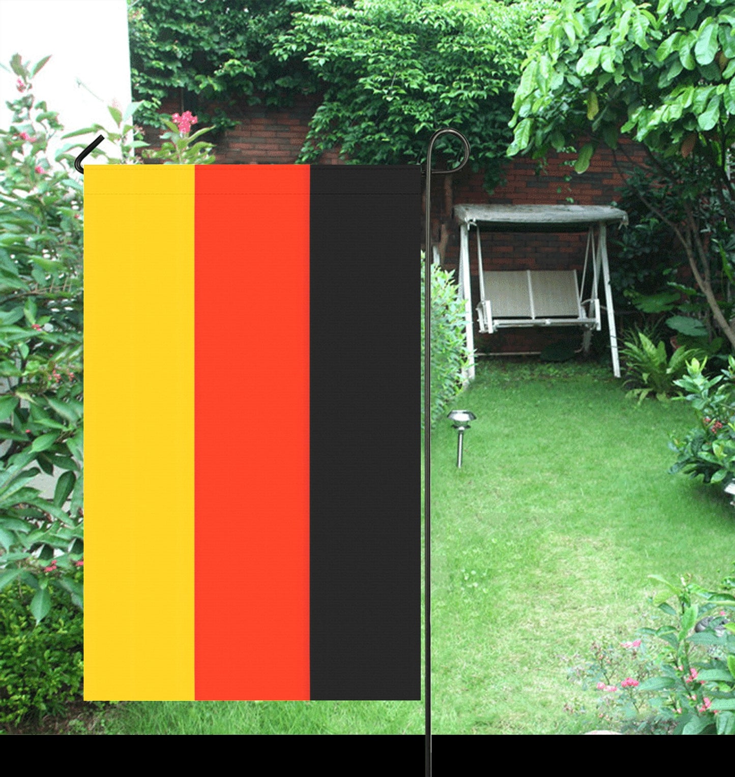 Luv My Flag garden flag in lush green backyard.