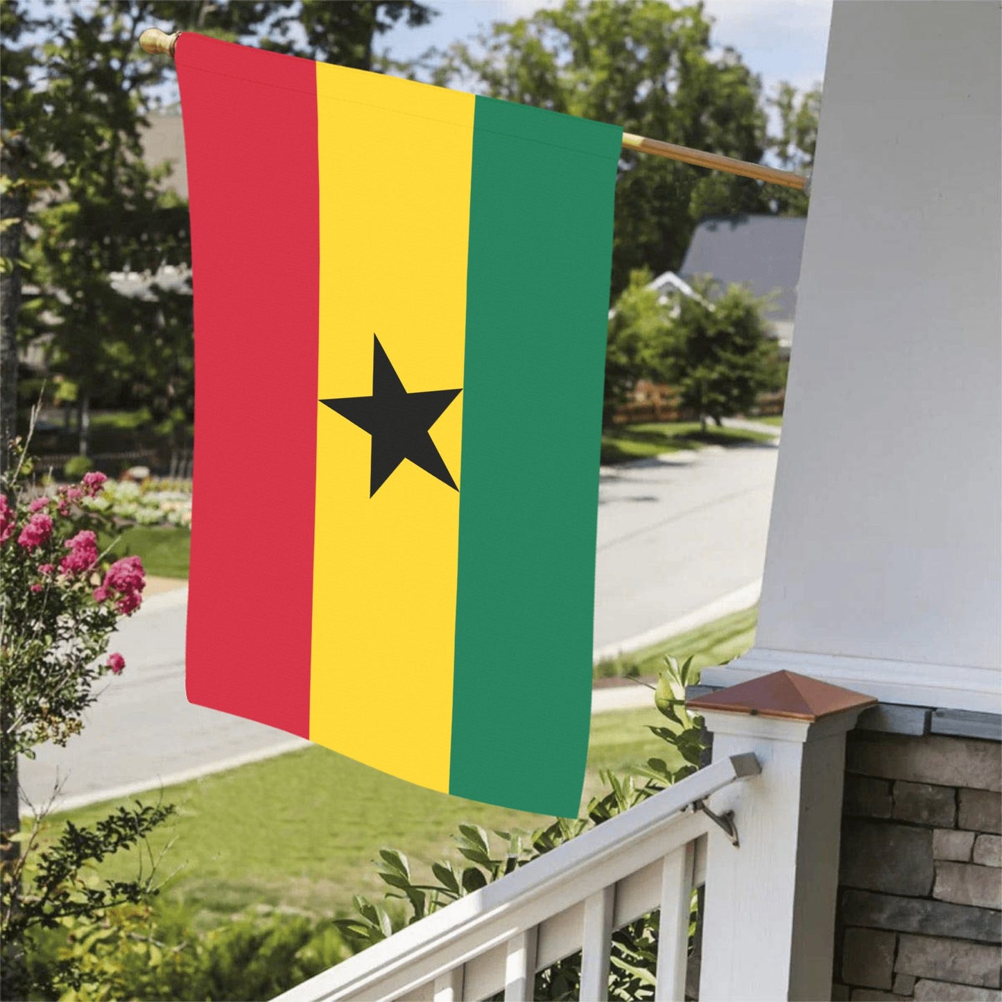 Luv My Flag brand flag featuring Ghana's colors, hanging outside.