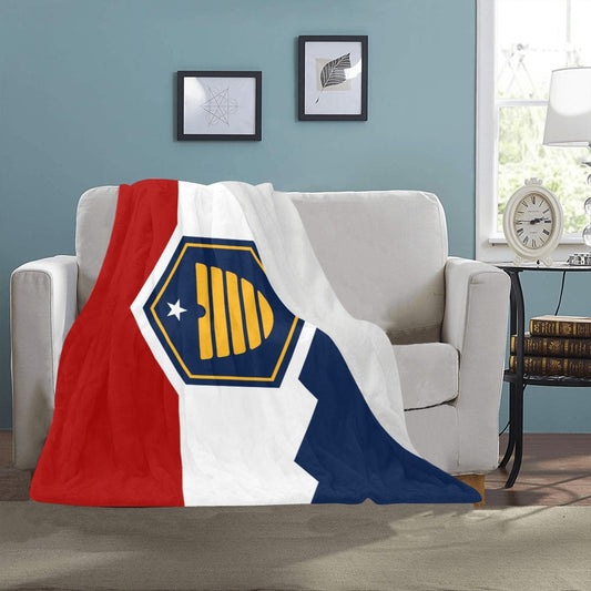 Cozy sofa with Luv My Flag patterned blanket draped.