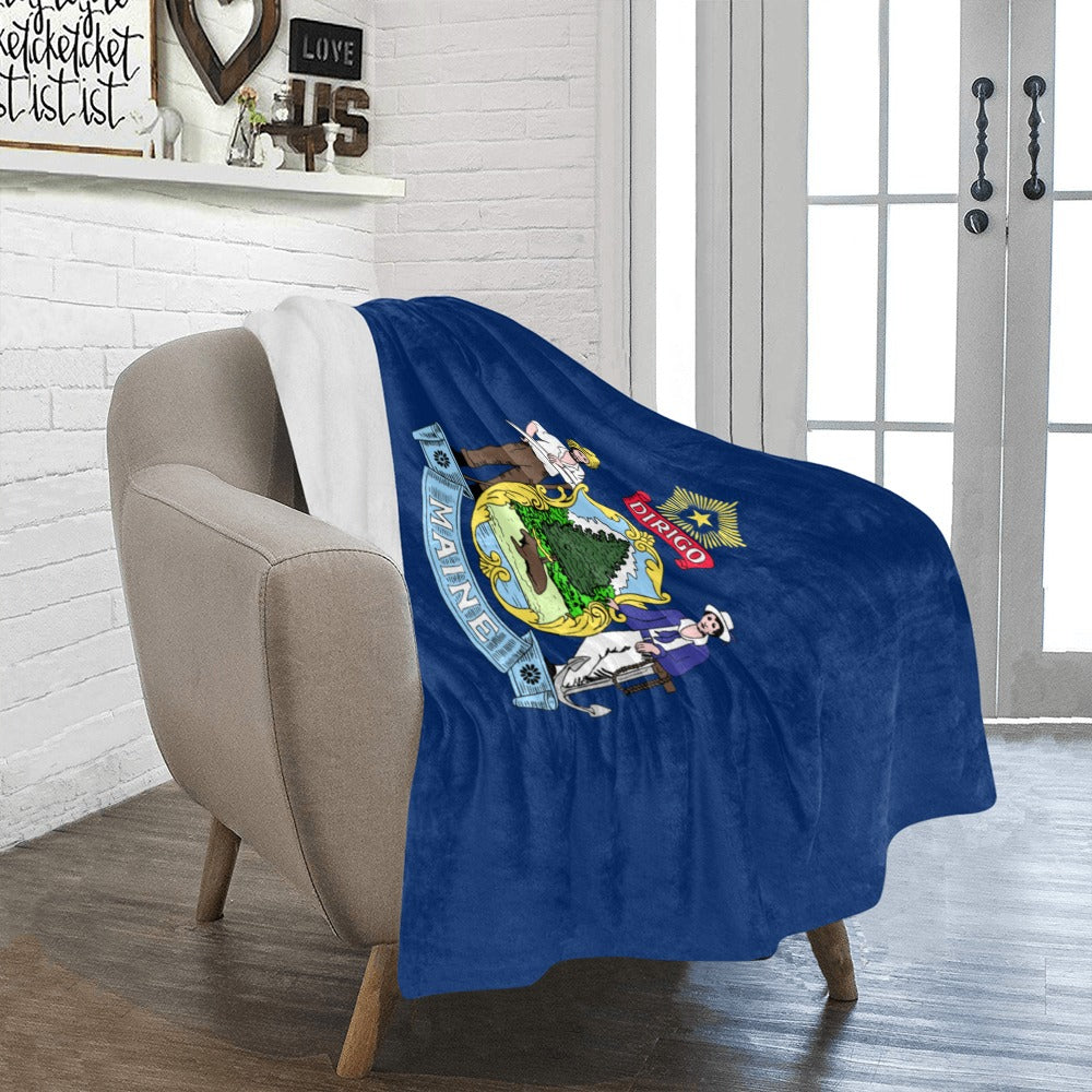 Cozy chair with Luv My Flag Maine-themed throw blanket.