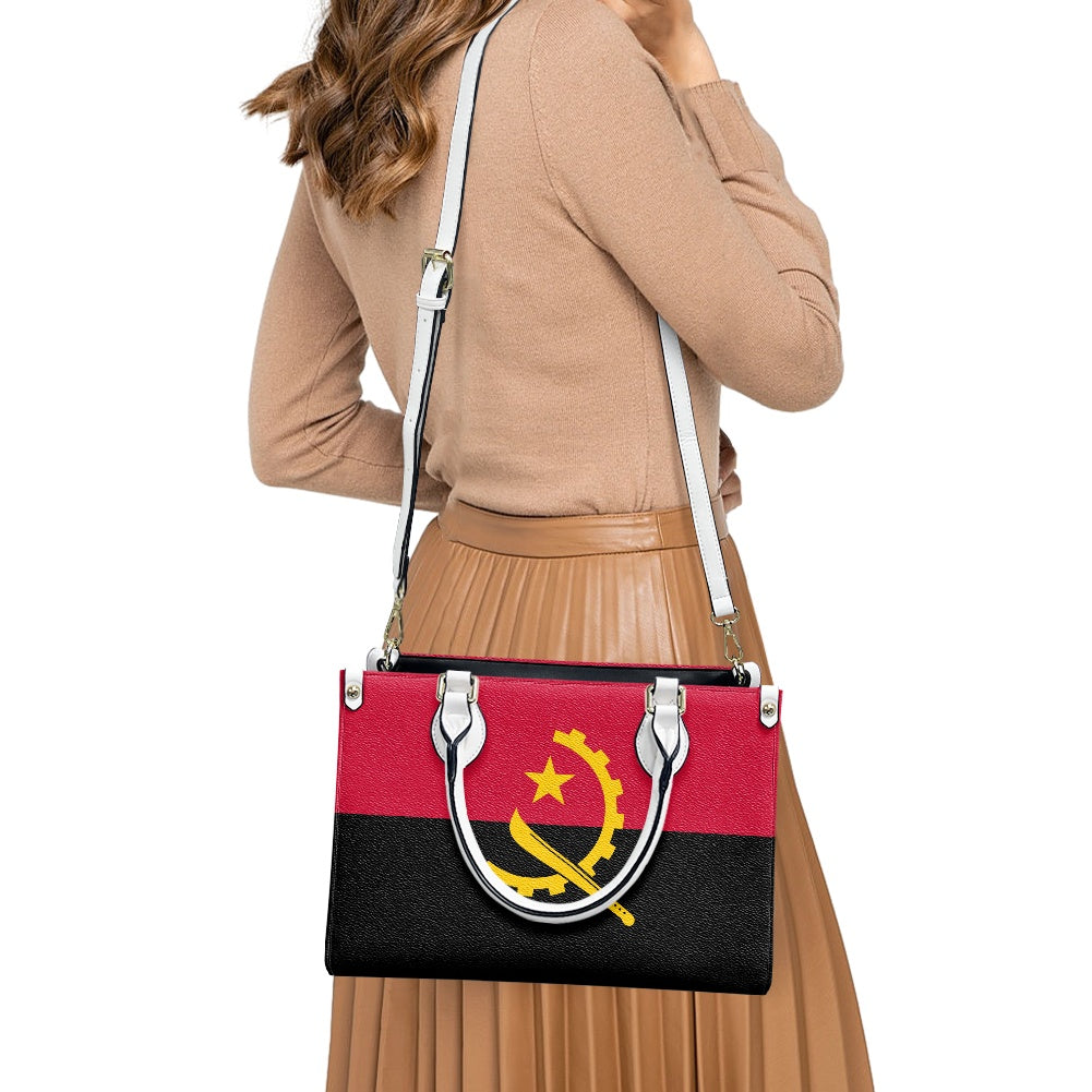 Woman carrying Luv My Flag handbag with Angolan design.