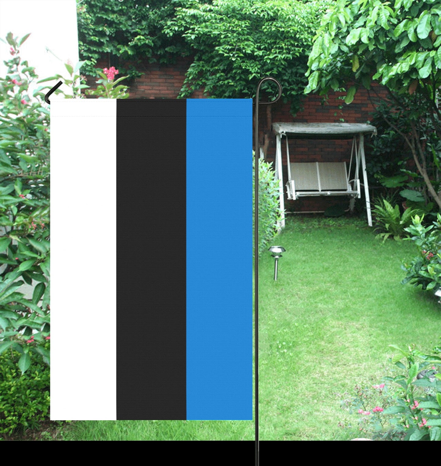 Luv My Flag tri-color garden flag in lush backyard.