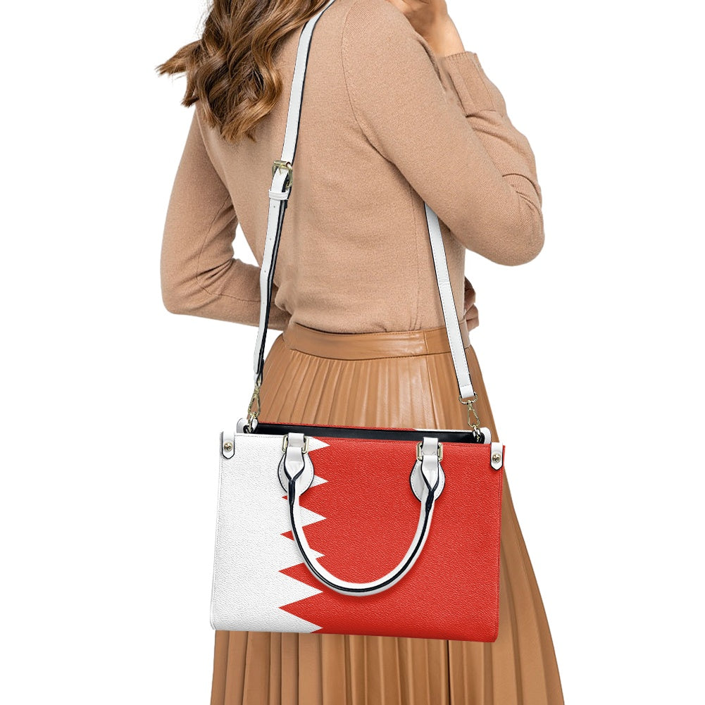 Woman carrying Luv My Flag handbag featuring red design.