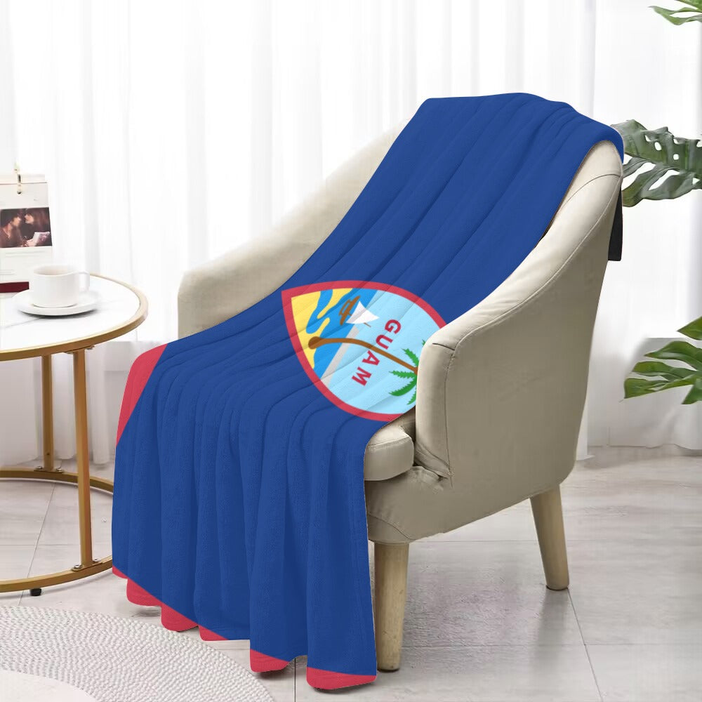 Blue Luv My Flag blanket with Guam emblem on chair.