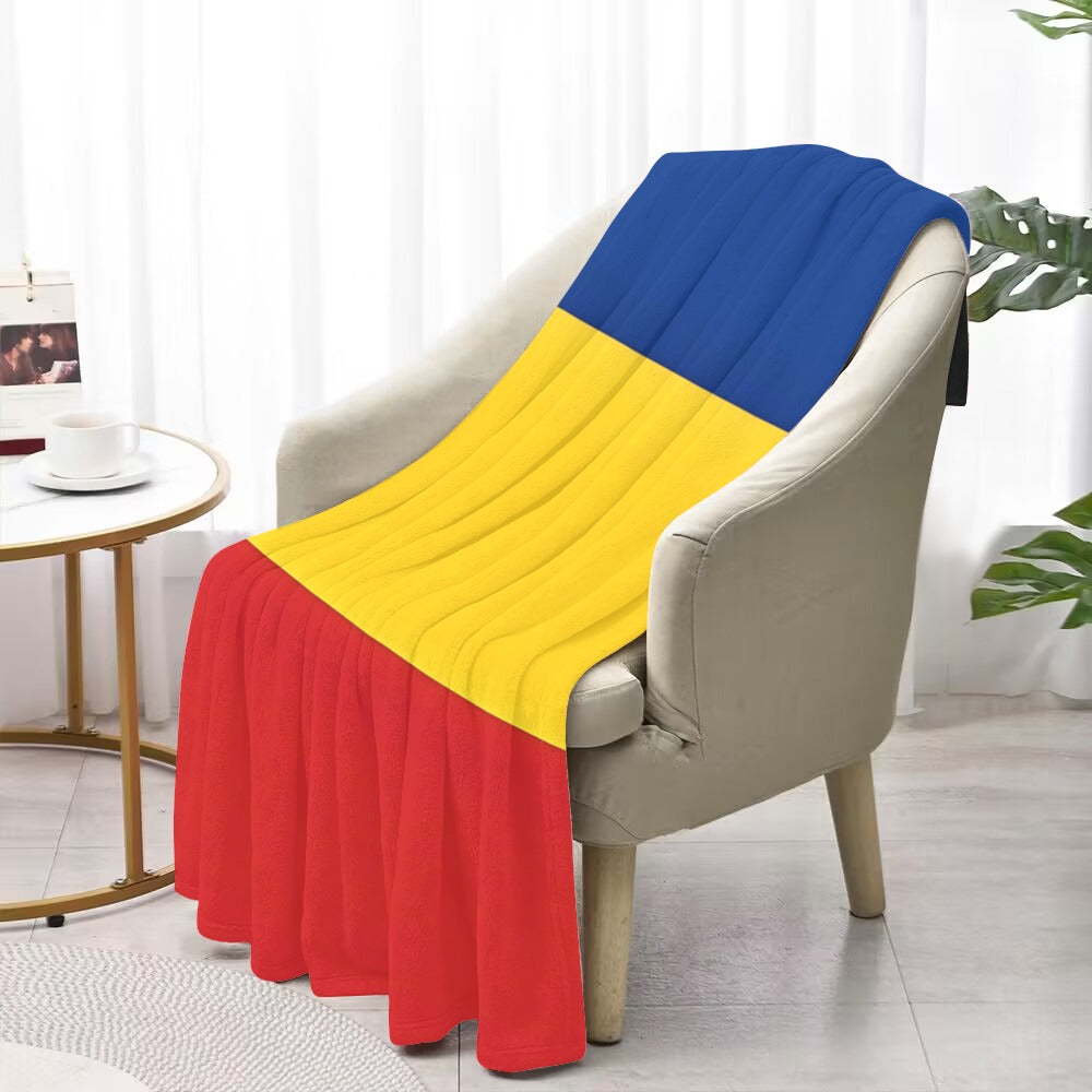 Cozy armchair with Luv My Flag tricolor blanket draped.