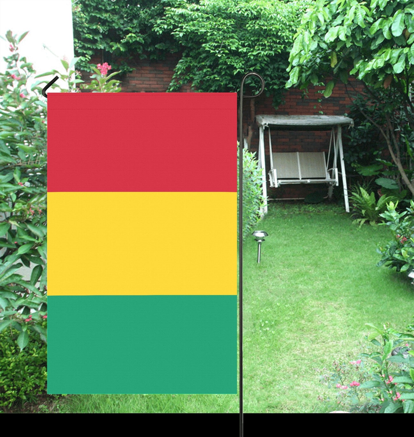 Luv My Flag: Colorful flag displayed in lush garden setting.