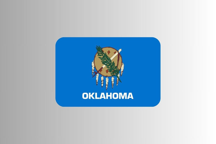Oklahoma state flag with a sky blue field featuring an Osage warrior’s shield made of buffalo hide, decorated with a peace pipe and olive branch crossed over the front, symbolizing peace.