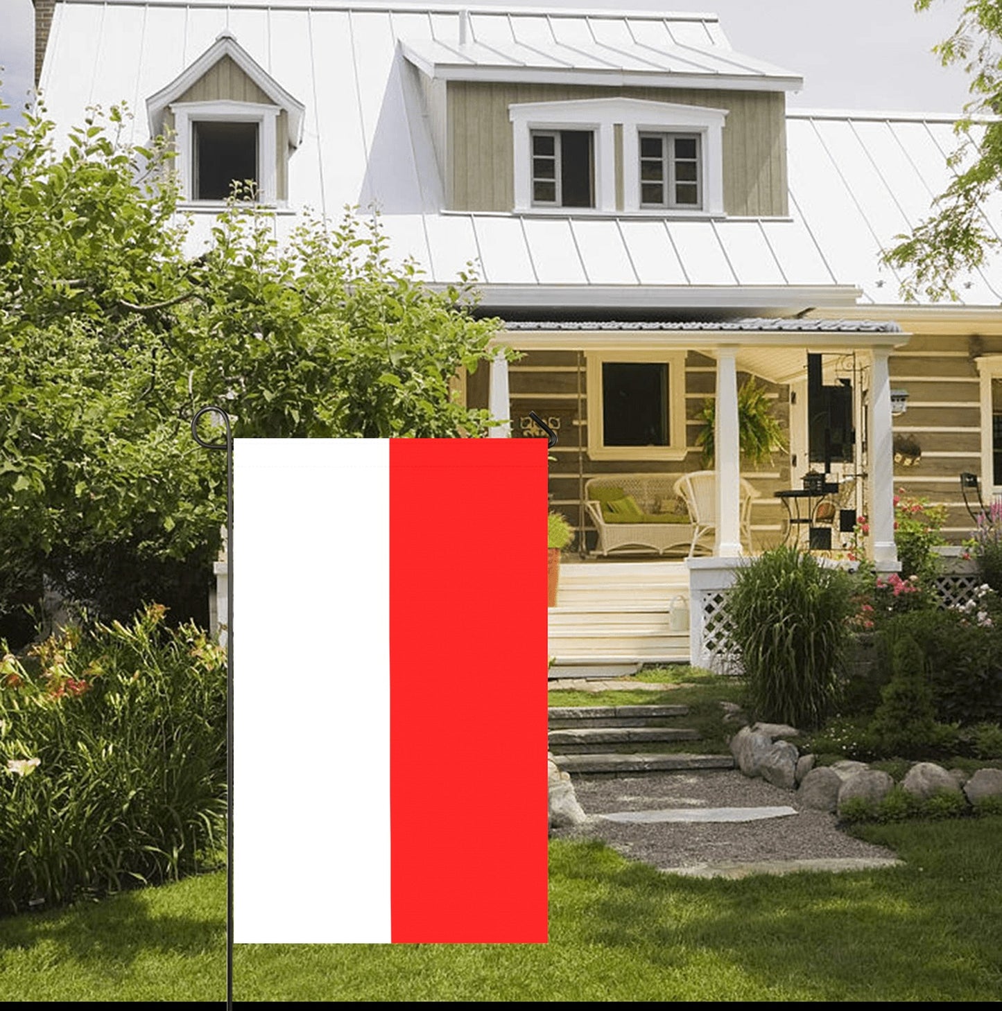 Red and white flag displayed in picturesque garden. [Luv My Flag]