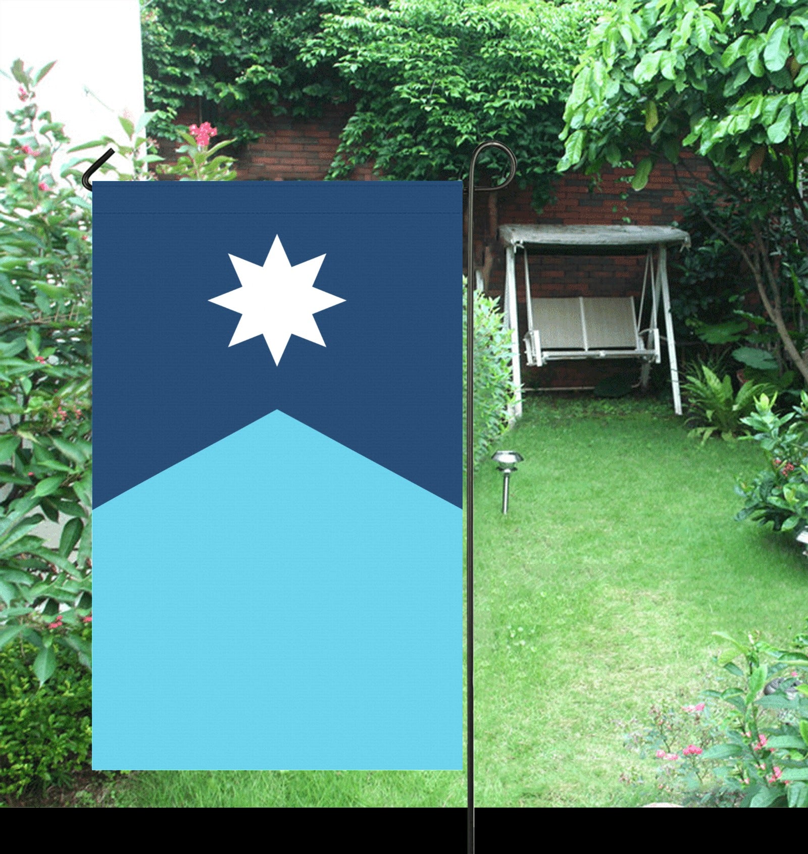 Luv My Flag: Blue flag in lush garden setting.