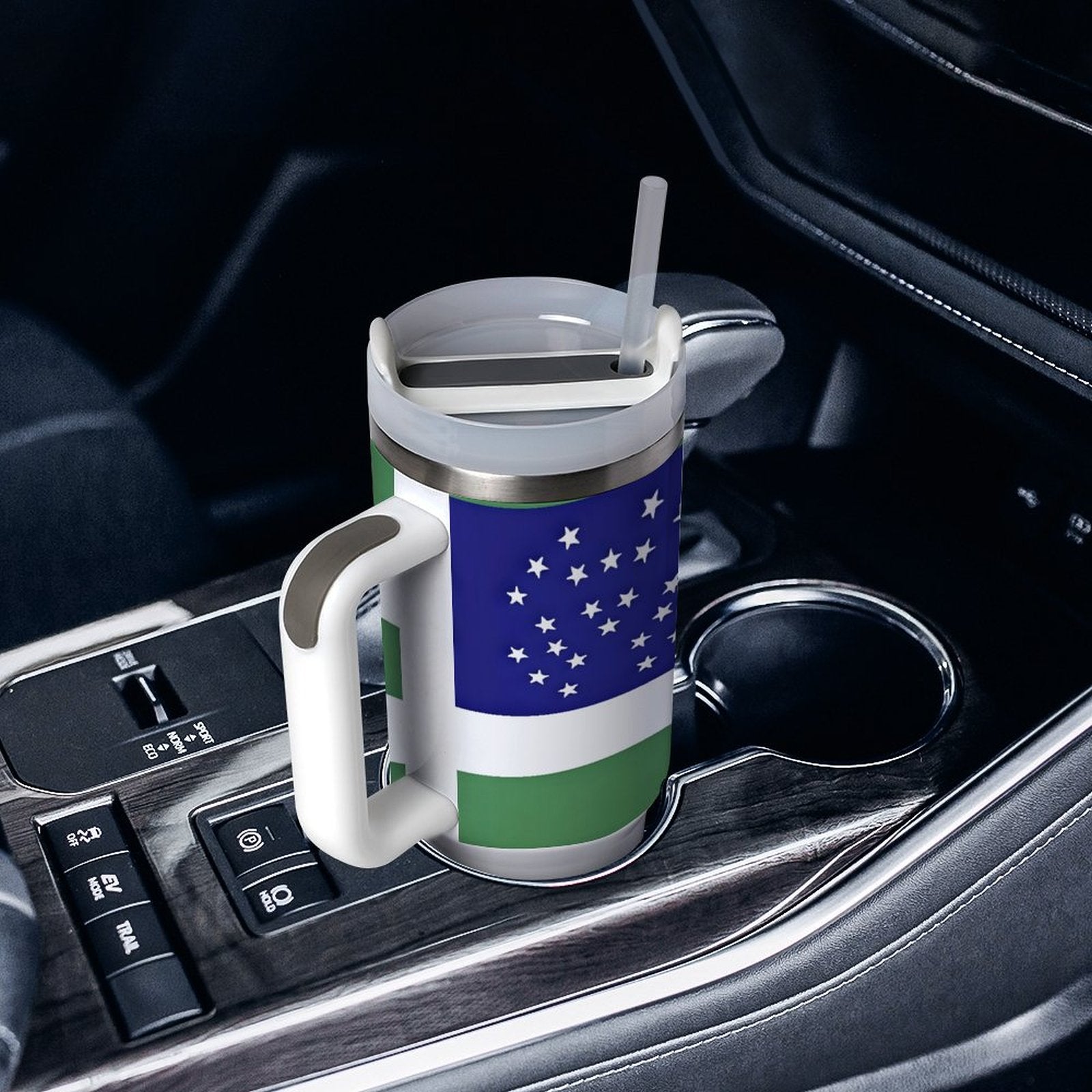 [Brand] mug with colorful design in car cup holder.
