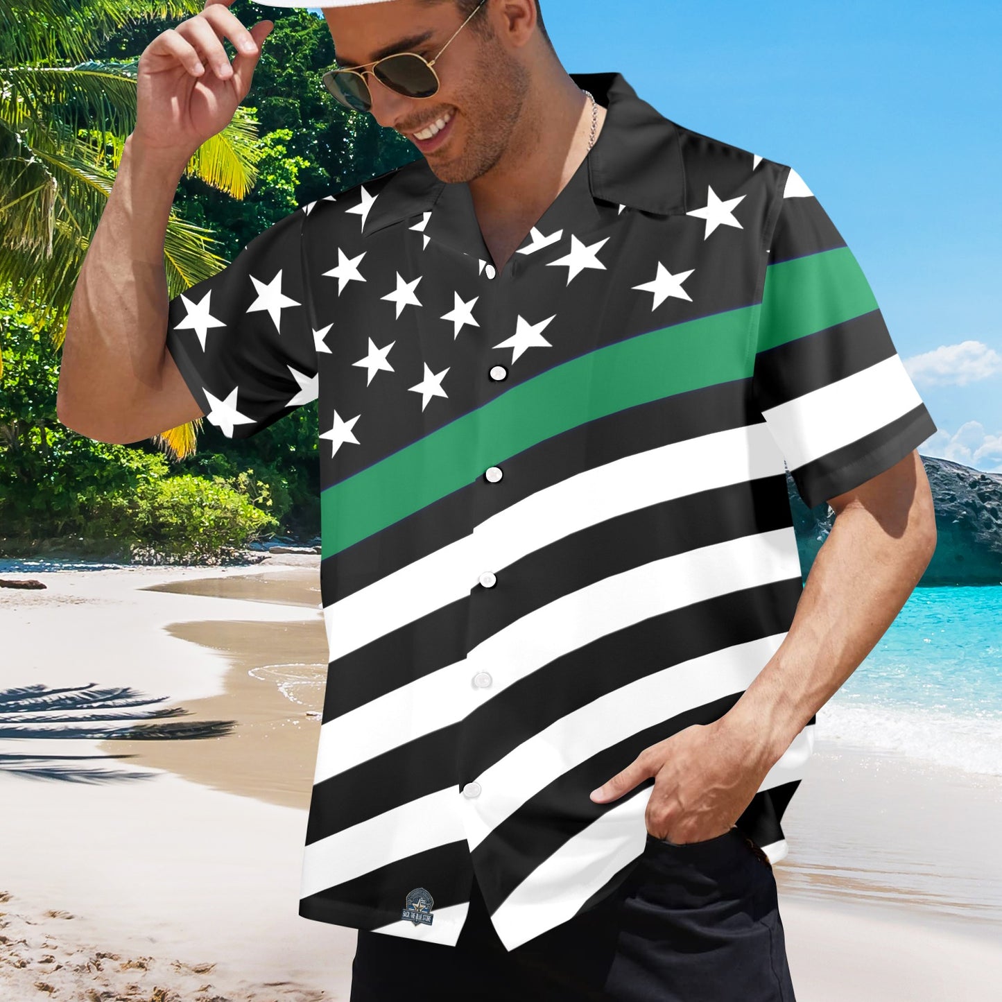 Man wearing [Brand] shirt with stars, stripes on beach.