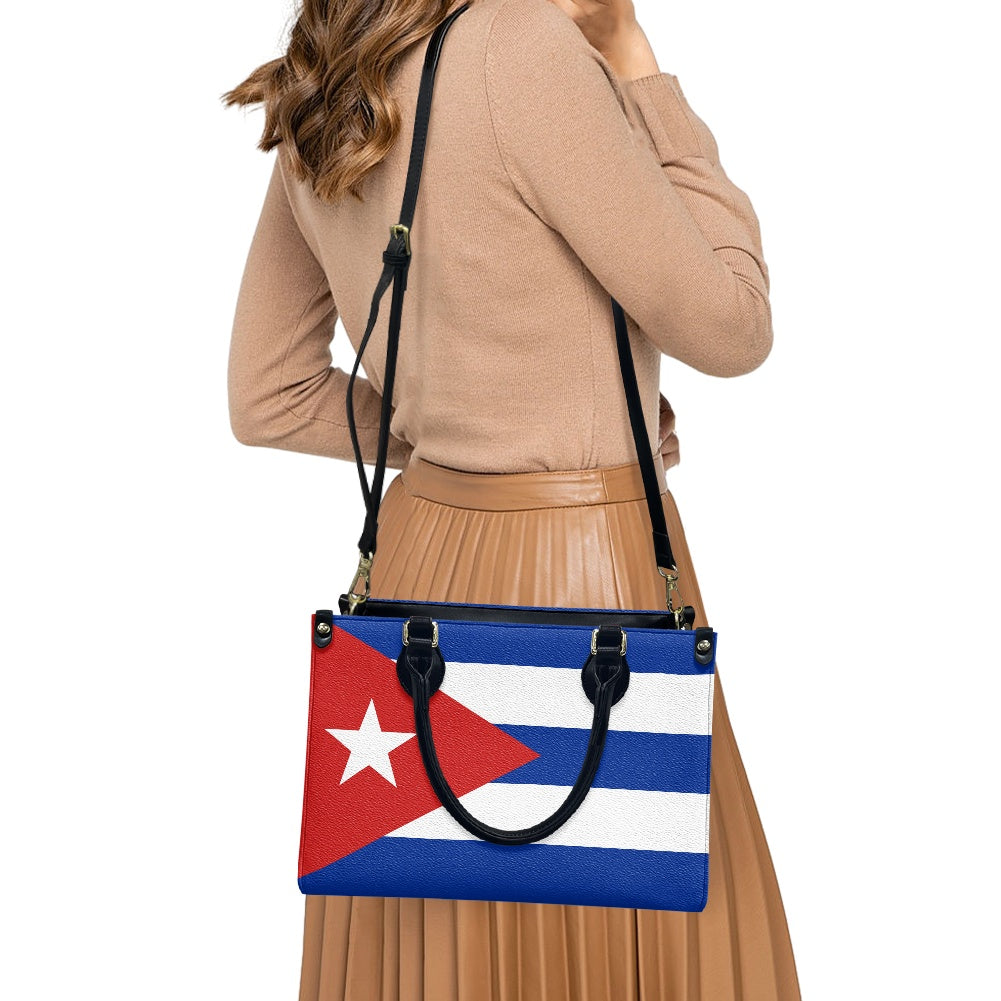 Woman carries [Brand] handbag with Cuban flag design.