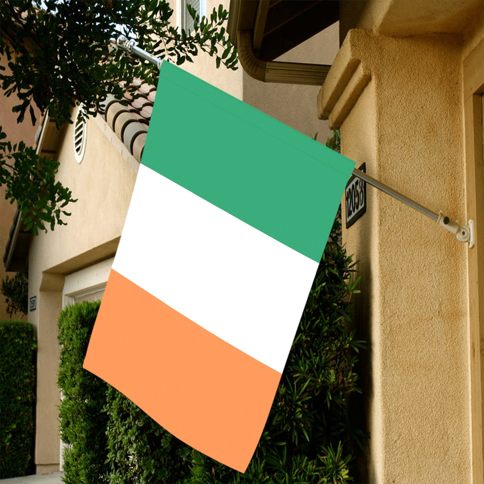 Irish flag by Luv My Flag displayed on house.