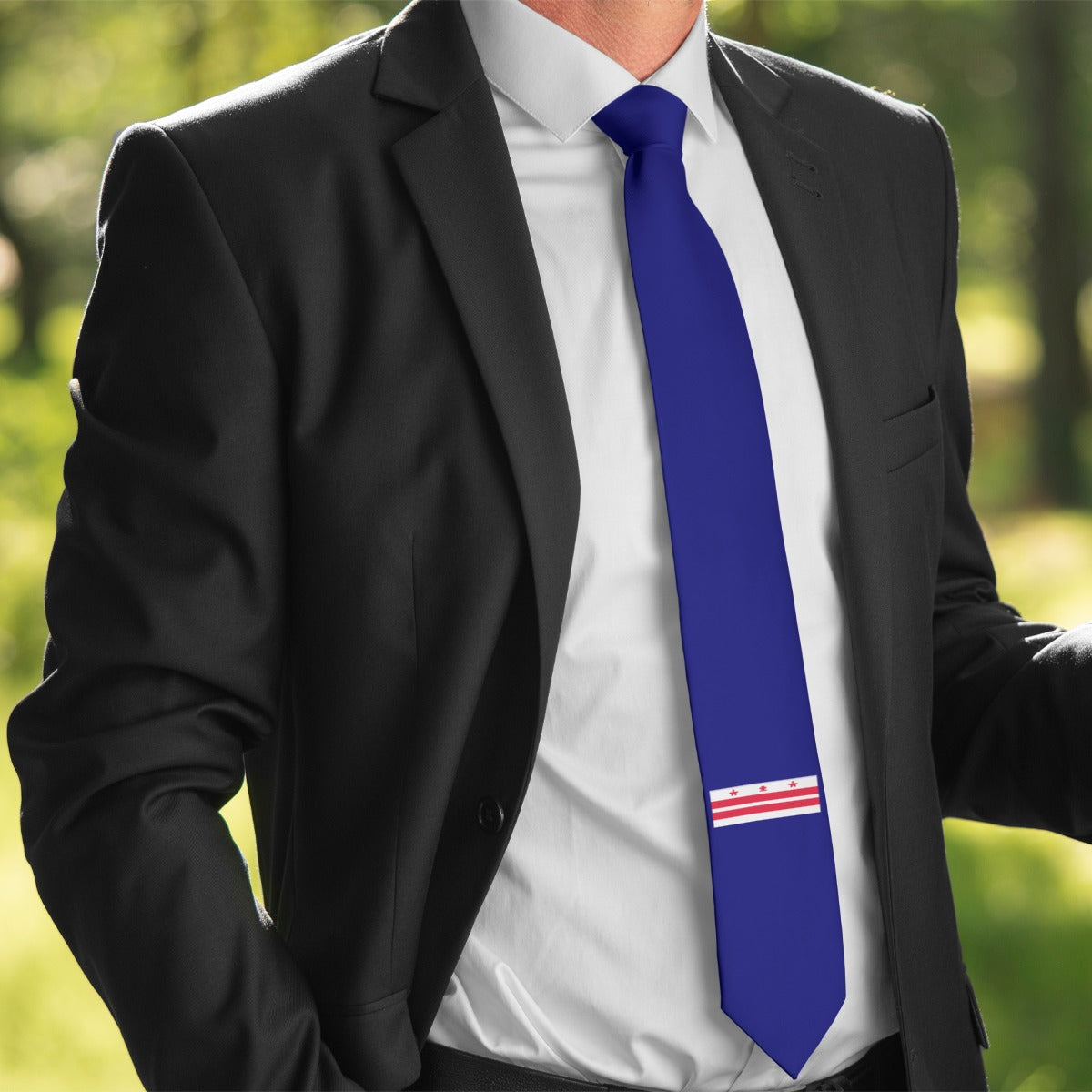 Person in suit with a [Brand] blue patterned tie.