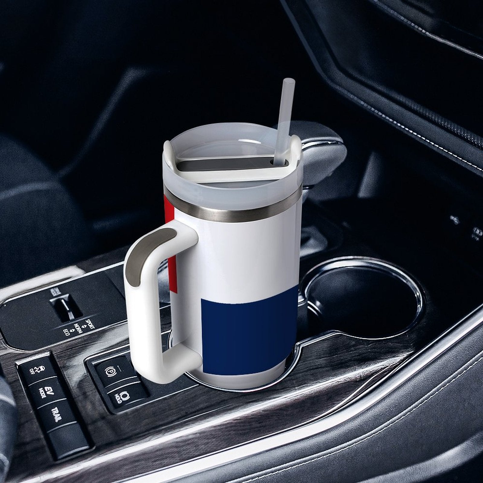 [Brand] travel mug with straw in car cup holder.