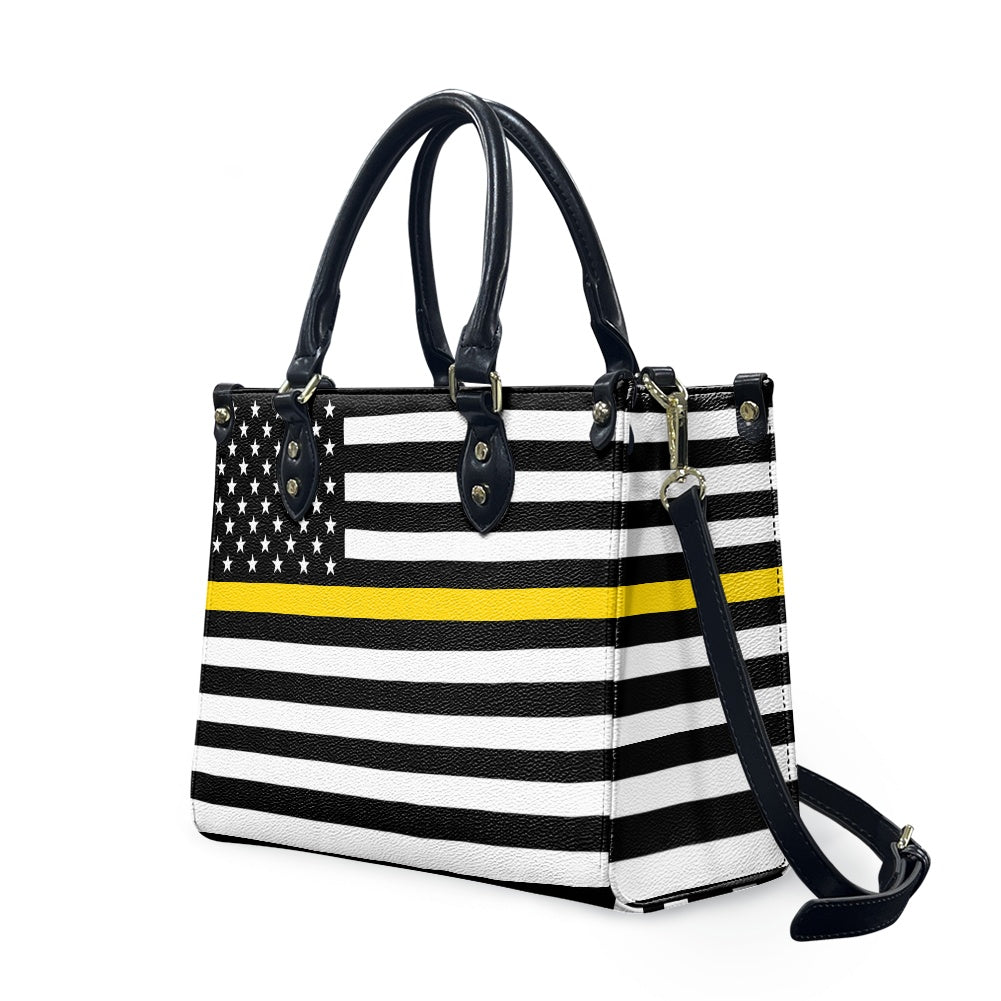 [Brand] handbag with black, white, yellow stripe design.