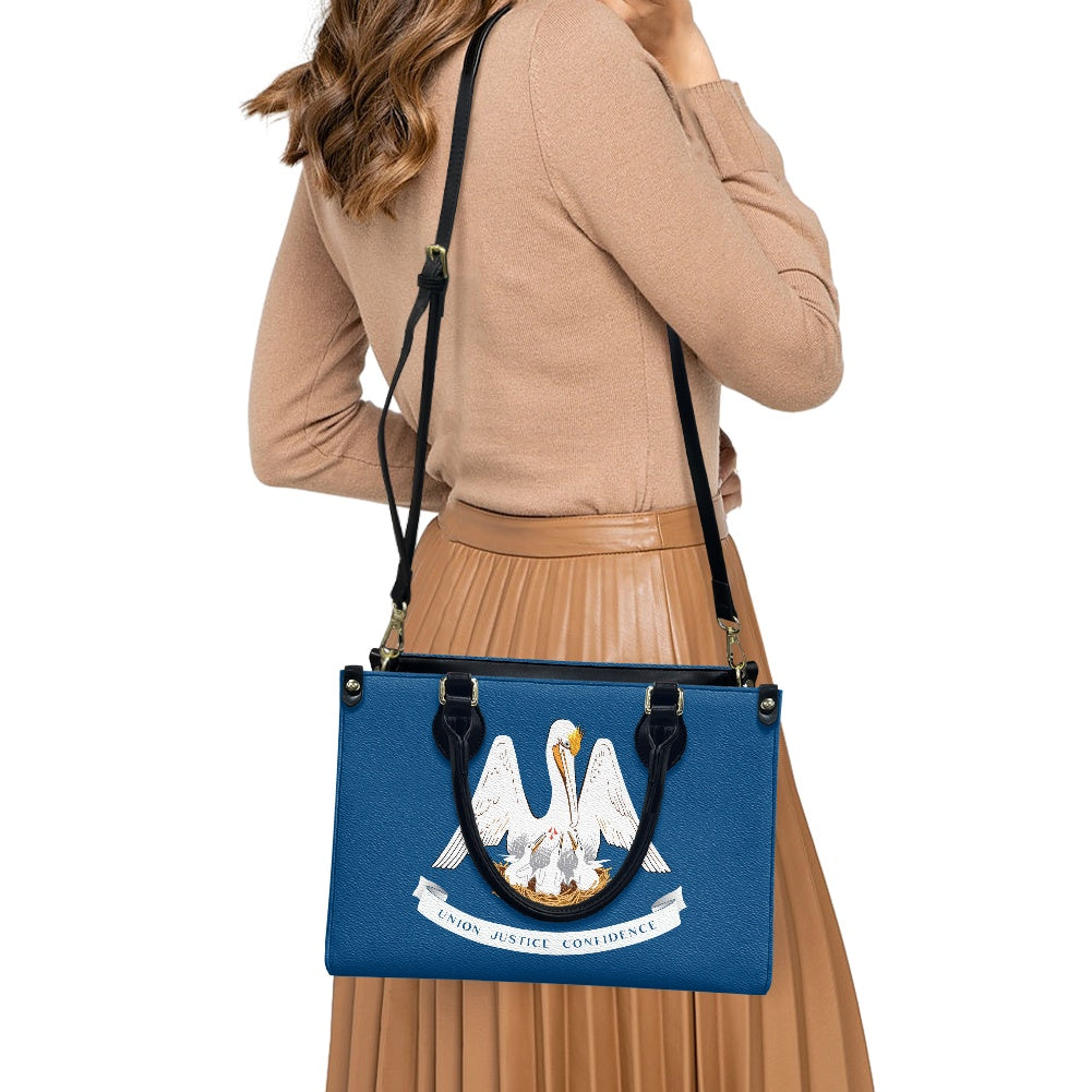 Woman carries [Brand] blue handbag with pelican design.
