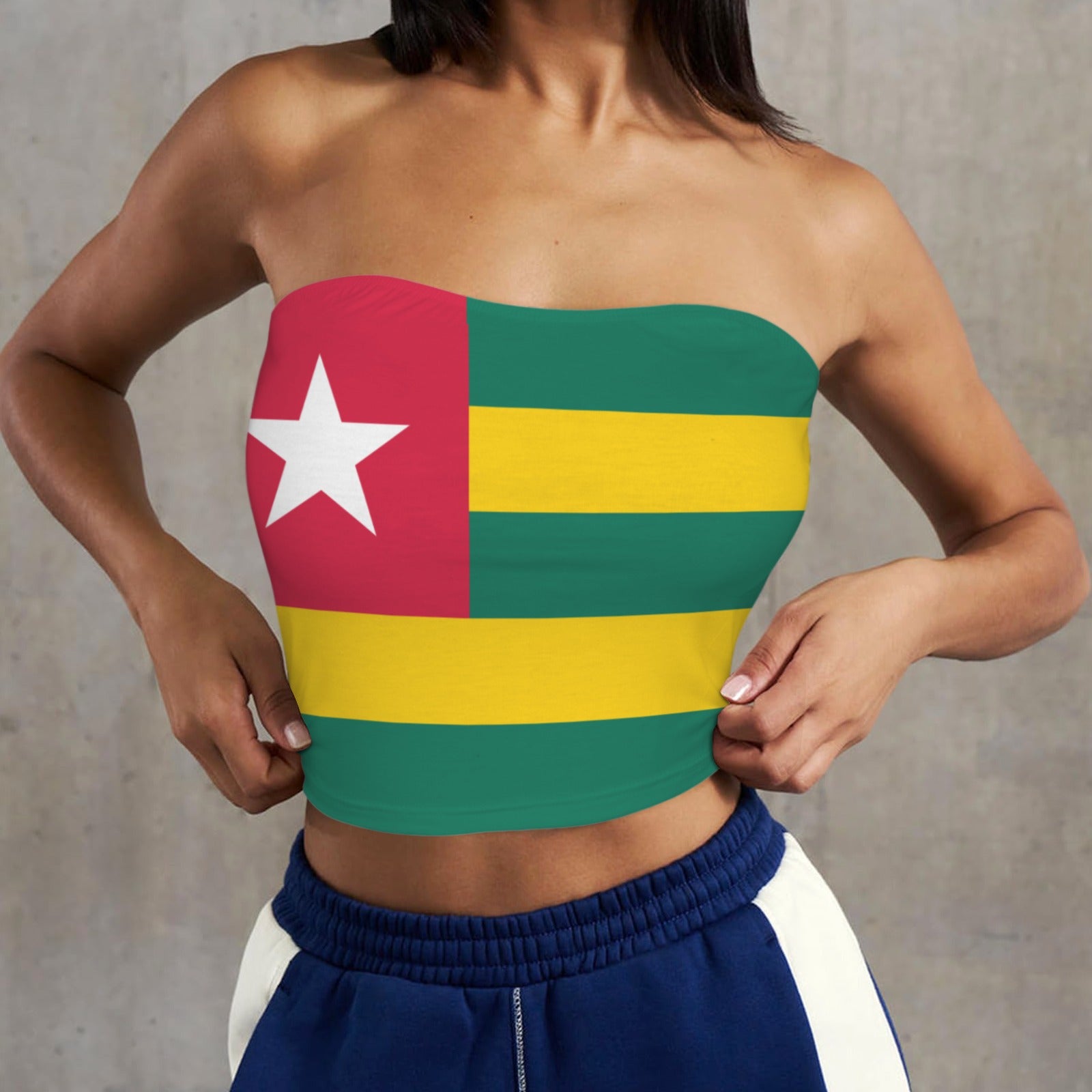 Woman wears [Brand] Togo flag top, navy blue pants.