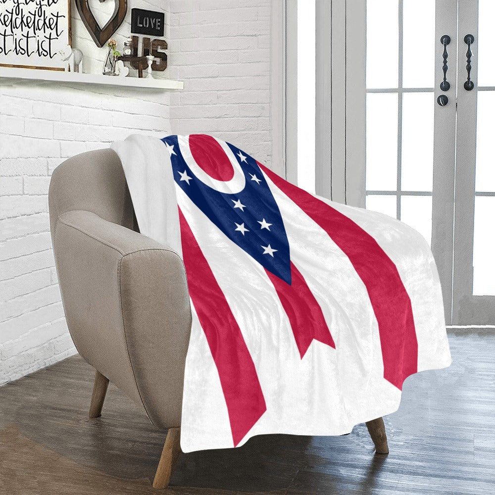 Cozy chair with Luv My Flag Ohio-themed blanket.