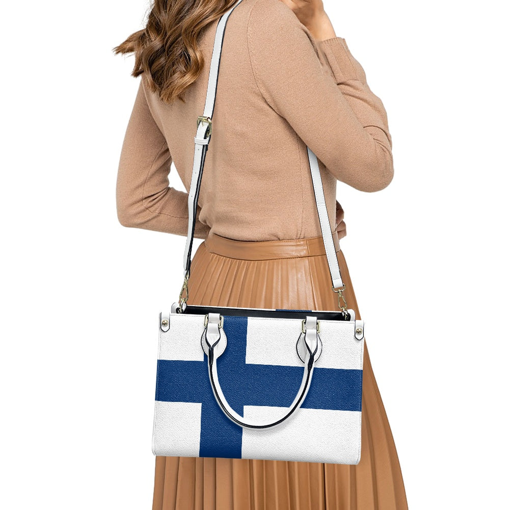 Woman carrying [Brand] handbag with Finnish flag design.