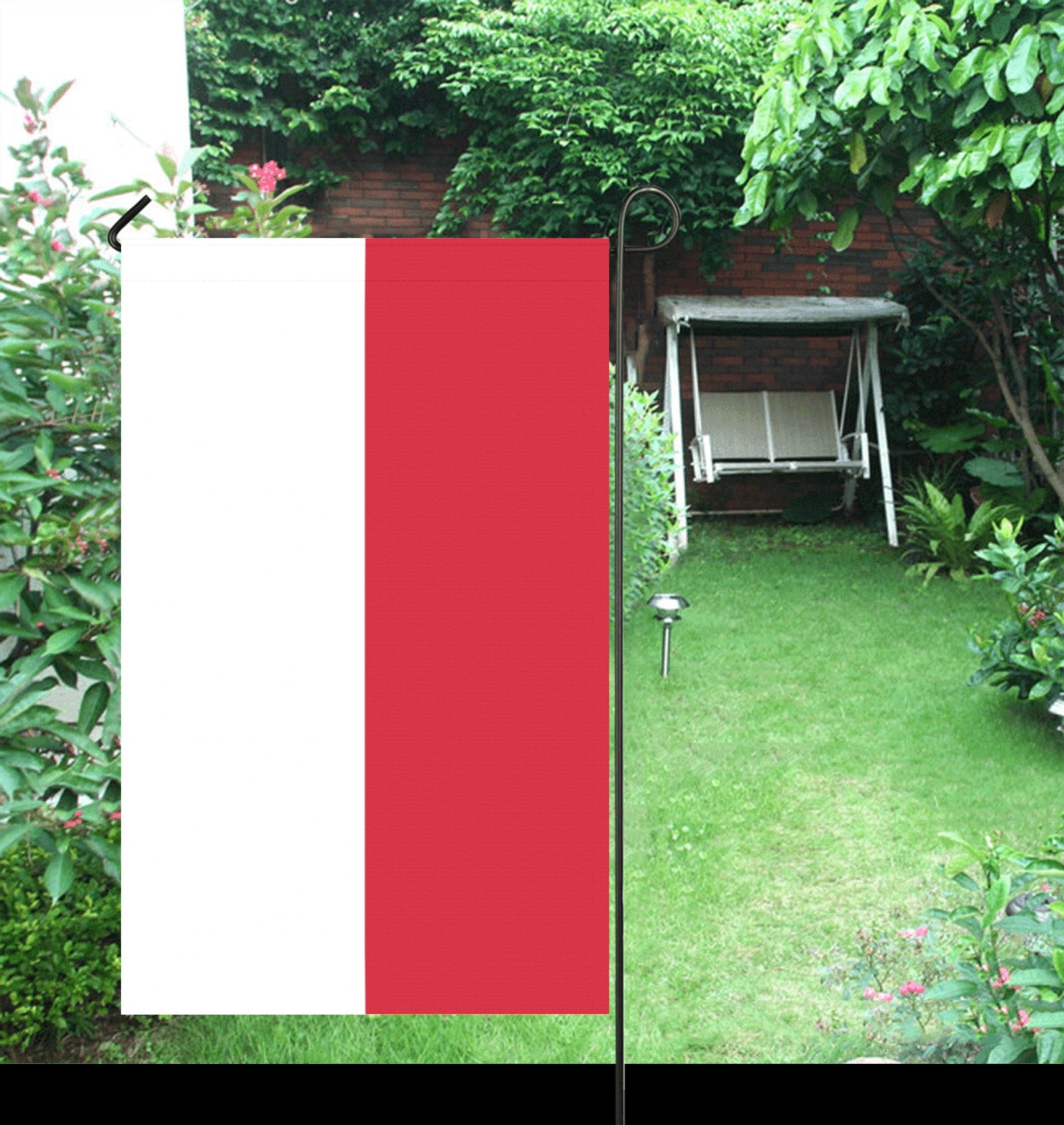 Luv My Flag garden flag amidst lush green backyard setting.