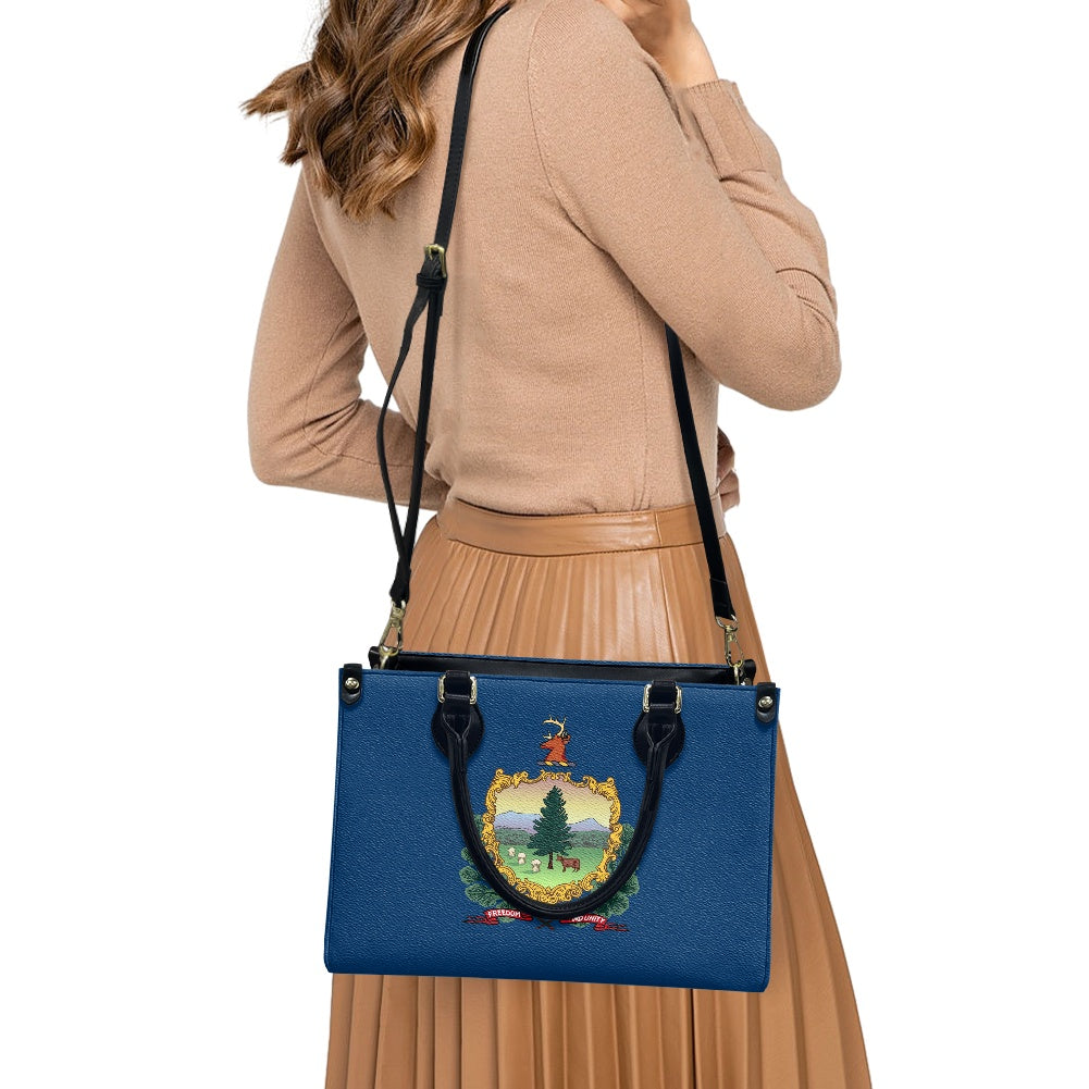 Woman carrying [Brand] blue handbag with crest design.