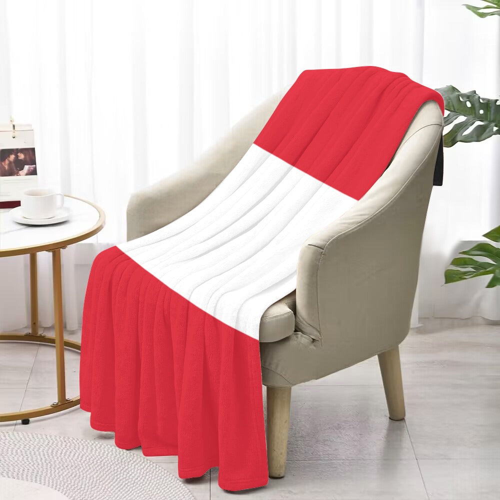 Red and white blanket on chair, Luv My Flag brand.