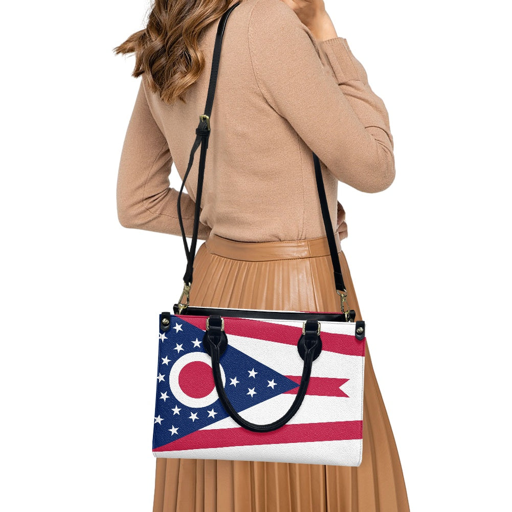 Woman carries [Brand] handbag featuring Ohio state flag design.