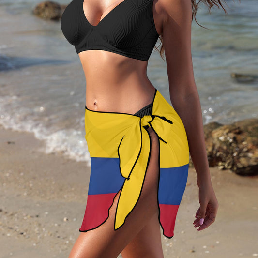 Woman in black bikini, [Brand] sarong with colorful pattern.