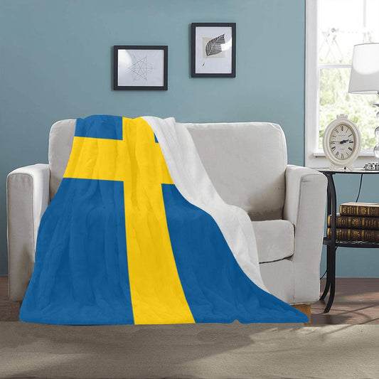 Luv My Flag blanket with Swedish flag on sofa.
