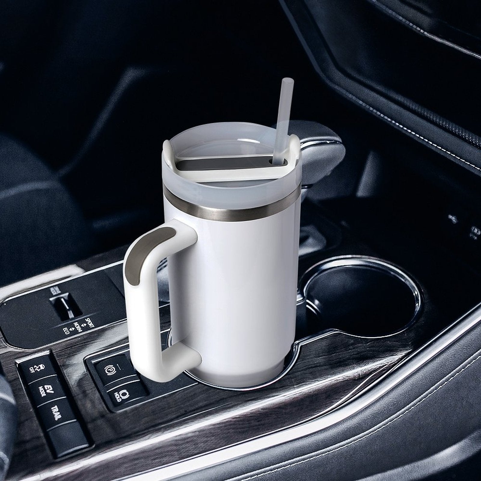 [Brand] white travel mug in car cup holder with straw.