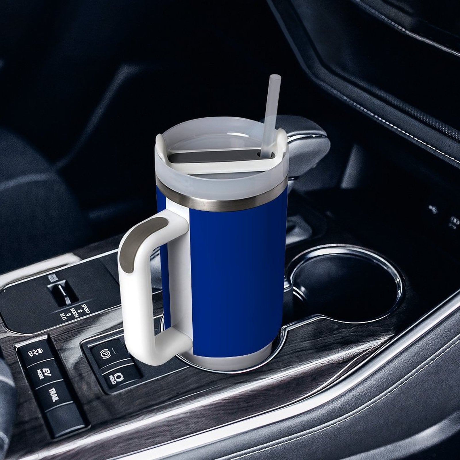 [Brand] blue travel mug with straw in car cupholder.