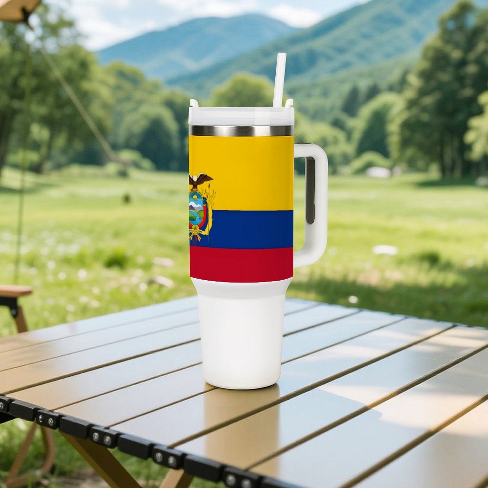 Stainless steel cup with Ecuador flag design on table.