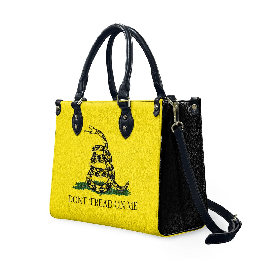 Yellow [Brand] handbag with snake design, "Don't Tread On Me."