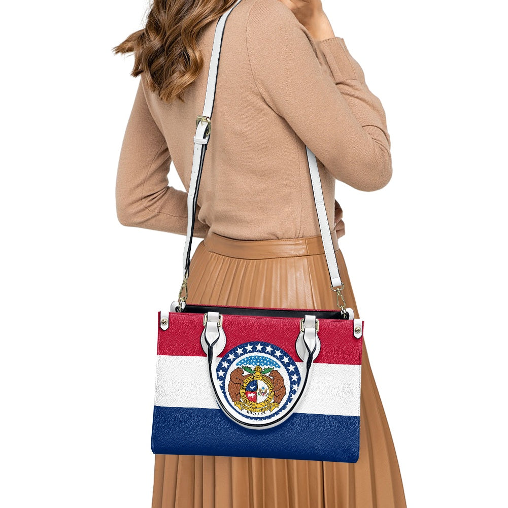 Woman carrying [Brand] handbag with Missouri flag design.